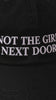 Close-up video of the embroidered Not the Girl Next Door black cap