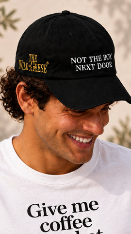 Man wearing The Wild Geese Not the Boy Next Door black embroidered cap